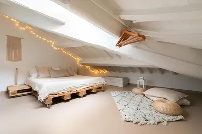a bedroom with a bed in a attic with lights at Rooftop Colosseum in Rome