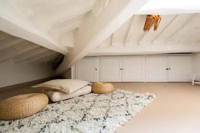 a attic room with a bed and a rug at Rooftop Colosseum in Rome