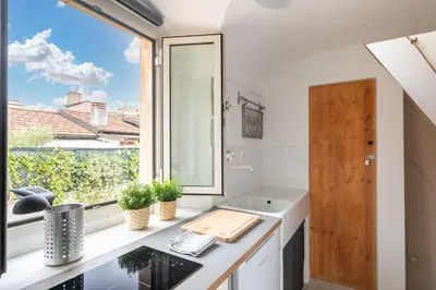 a bathroom with a sink and a window at Rooftop Colosseum in Rome