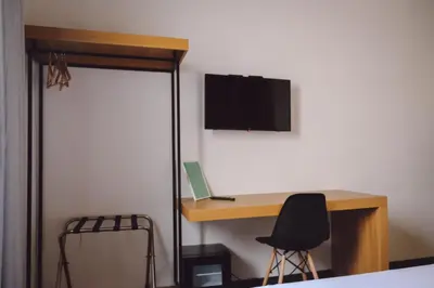 a room with a desk with a computer and a chair at Central Lodge Hotel in Rome