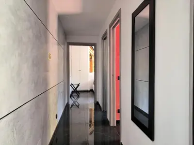 a hallway of a house with white walls and black floors at Balcone sul parco in Rome