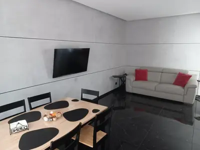 a living room with a table and a couch at Balcone sul parco in Rome