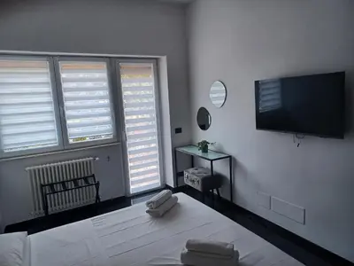 a bedroom with a bed and a flat screen tv at Balcone sul parco in Rome