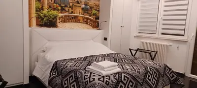 a bedroom with a bed with towels on it at Balcone sul parco in Rome
