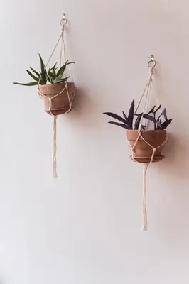two plants in pots hanging on a wall at Marconi 31 Rome Holiday House - Rome Vacation M&D in Rome