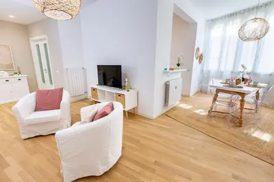 a living room with two white chairs and a table at Noh collection 3BDR apartment- Trastevere Area in Rome