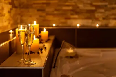 a bathroom with two glasses of champagne and candles at Five Rooms Rome Guesthouse in Rome