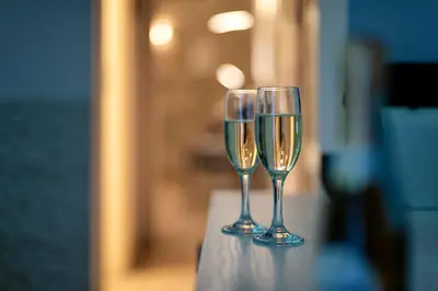 two glasses of champagne sitting on top of a table at Five Rooms Rome Guesthouse in Rome