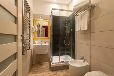 a bathroom with a sink and a toilet and a shower at Five Rooms Rome Guesthouse in Rome