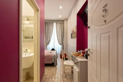 a bathroom with a sink and a bathroom with a bed at Five Rooms Rome Guesthouse in Rome