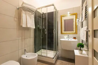 a bathroom with a shower and a toilet and a sink at Five Rooms Rome Guesthouse in Rome