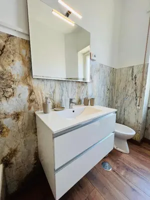 a bathroom with a white sink and a toilet at Stazione Tiburtina - Camesena Apartment in Rome