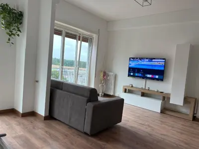 a living room with a couch and a flat screen tv at Stazione Tiburtina - Camesena Apartment in Rome