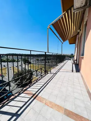 a balcony of a building with a view of the ocean at Stazione Tiburtina - Camesena Apartment in Rome