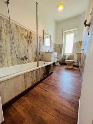 a large bathroom with a tub and a sink at Stazione Tiburtina - Camesena Apartment in Rome