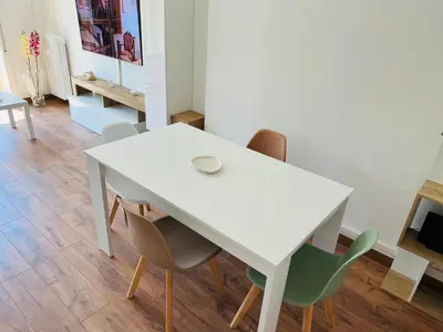 a white table and chairs in a room at Stazione Tiburtina - Camesena Apartment in Rome