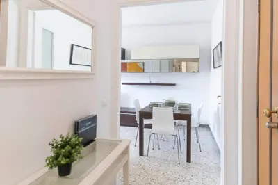 a dining room with a table and a mirror at [Centro Storico-5min Vaticano] Domus in Rome