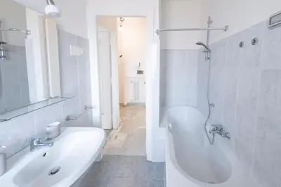a white bathroom with a tub and a sink at [Centro Storico-5min Vaticano] Domus in Rome