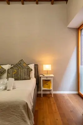 a bedroom with a bed and a table with a lamp at Roma Centro Storico Luxury - Via del Corso in Rome