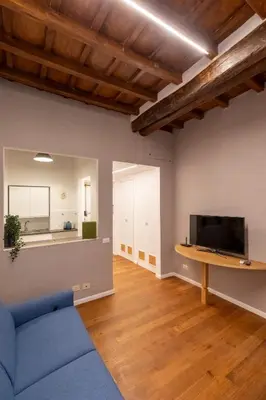 a living room with a blue couch and a tv at Roma Centro Storico Luxury - Via del Corso in Rome