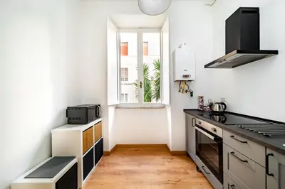 a kitchen with a stove top oven next to a window at VATICAN VIBES in Rome