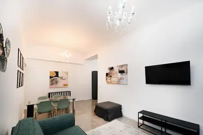 a living room with a table and a tv at VATICAN DESIGN APARTMENTS in Rome