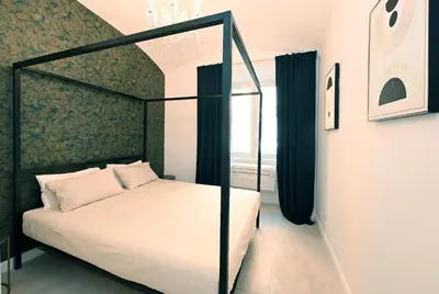 a bedroom with a canopy bed and a window at VATICAN DESIGN APARTMENTS in Rome