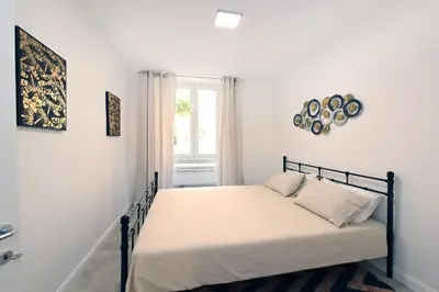 a bedroom with a bed in a white room at VATICAN DESIGN APARTMENTS in Rome