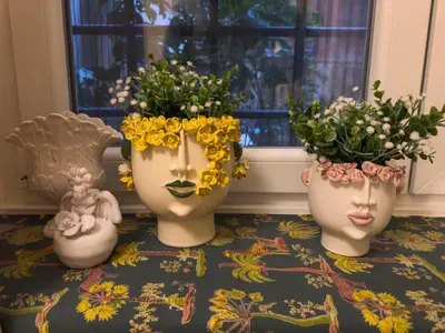 three vases with flowers in them sitting on a table at Via Giulia Charming Atelier apartment in Rome