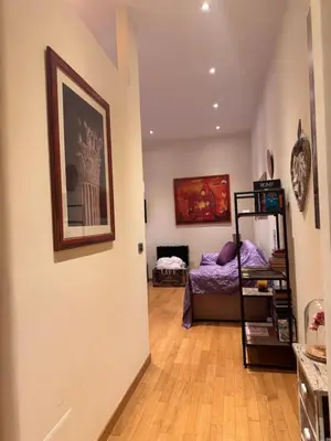 a room with a room with a bed and a hallway at Roma Da Noi Suite in Rome