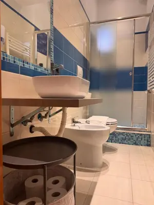a bathroom with a sink and a toilet at Roma Da Noi Suite in Rome