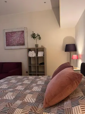 a bedroom with a bed with two pillows on it at Roma Da Noi Suite in Rome