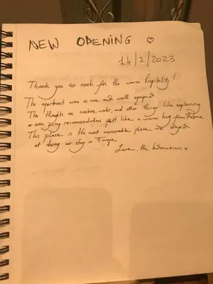 a handwritten letter on top of a spiral notebook at Roma Da Noi Suite in Rome