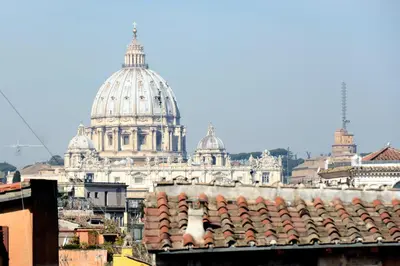 a view of a city with a cathedral in the background at Appartamento Coronari in Rome