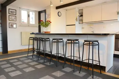 a kitchen with bar stools at a counter at Appartamento Coronari in Rome