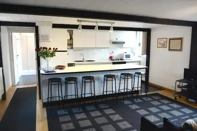 a kitchen with a island with bar stools at Appartamento Coronari in Rome