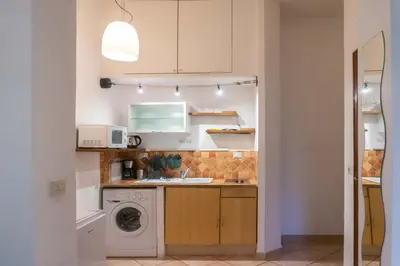 a kitchen with a washing machine and a washer at EasyTopStay - Monti Studio Apartment in Rome