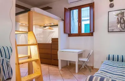 a room with a bunk bed and a desk and a ladder at EasyTopStay - Monti Studio Apartment in Rome