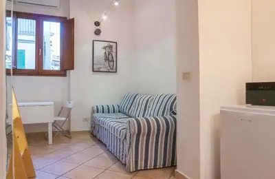 a living room with a couch and a table at EasyTopStay - Monti Studio Apartment in Rome