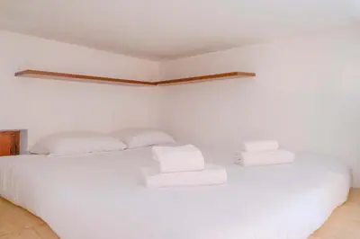 a bedroom with a white bed with two pillows at EasyTopStay - Monti Studio Apartment in Rome