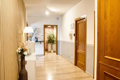 a hallway with a door and a vase with flowers at Di Martino Residence in Rome
