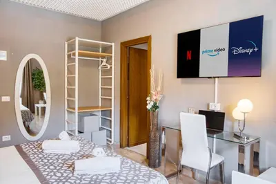 a living room with a table and a tv on the wall at Di Martino Residence in Rome