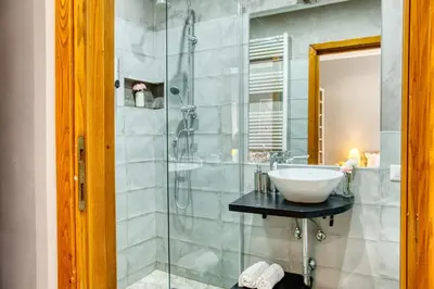 a bathroom with a sink and a glass shower at Di Martino Residence in Rome