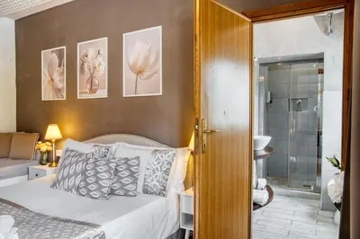 a bedroom with a bed and a walk in shower at Di Martino Residence in Rome