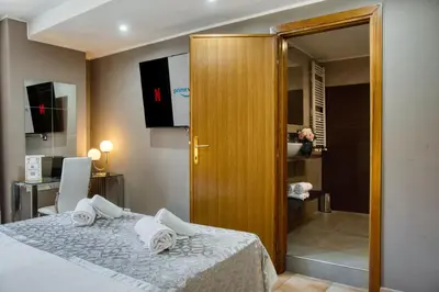 a bedroom with a bed with towels on it at Di Martino Residence in Rome