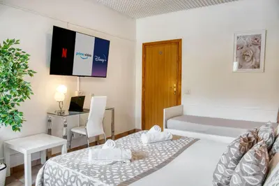 a small room with a bed and a desk at Di Martino Residence in Rome