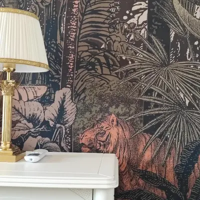 a lamp sitting on a table with a monkey wallpaper at Oasi Urbana San Paolo in Rome