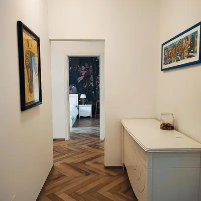 a room with a desk and a hallway with a painting at Oasi Urbana San Paolo in Rome