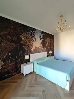 a bedroom with a blue bed and a wall mural at Oasi Urbana San Paolo in Rome