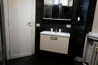 a bathroom with a white sink and a mirror at Ermete Vatican House in Rome